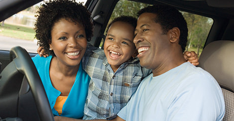 Happy parents and son sitting in front of the car photo